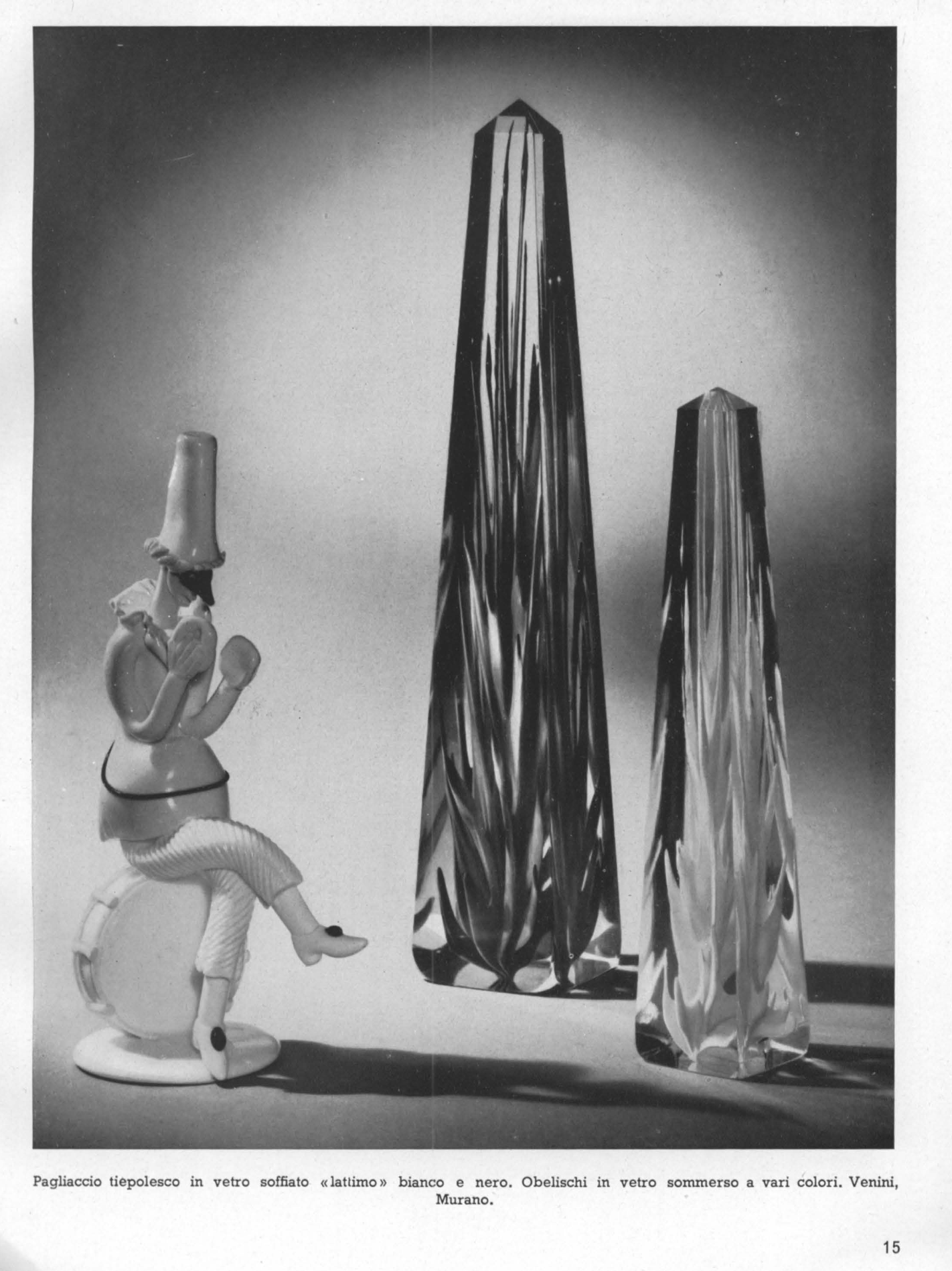 Blown glass clown in Tiepolo's style white and black lattimo*. Polychromous submerged glass obelisks.